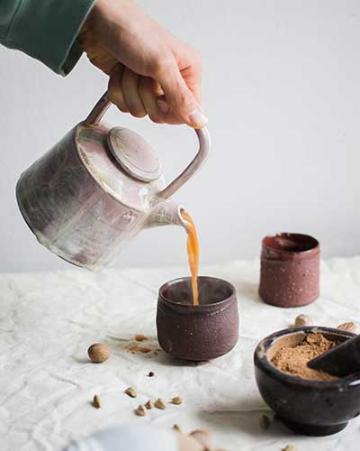 pouring chai into a cup